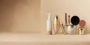 SENSAI Sustainable Care product lineup on a beige surface against a neutral background